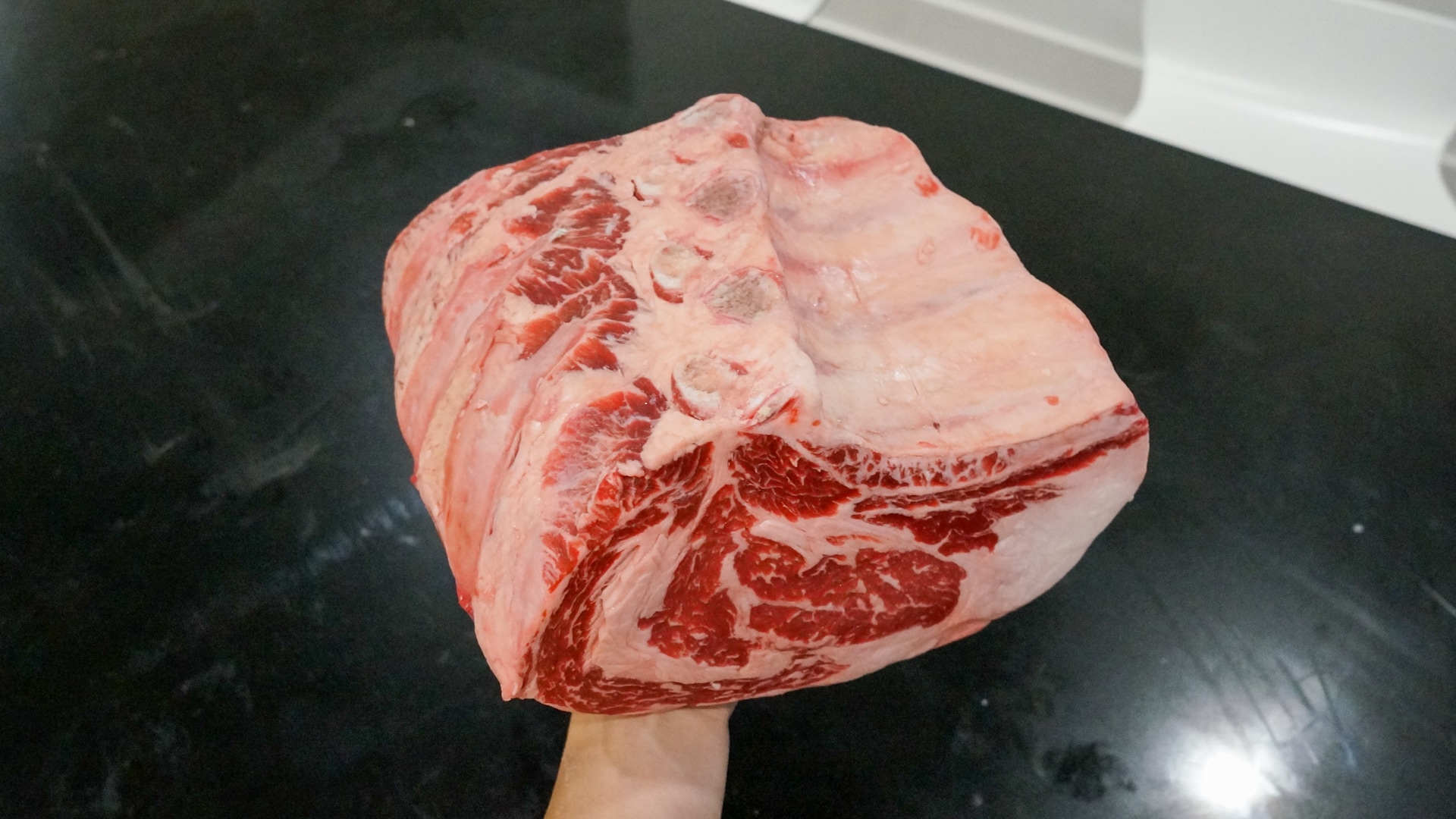 Holding the prime rib cut for scale